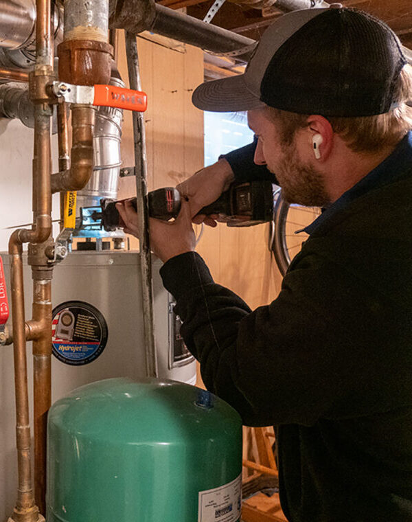 Home 4 Electrification water heater removal worker e1756896934501